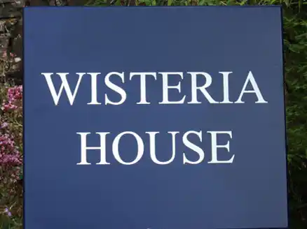 Steel blue painted house sign with white letters