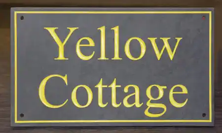 Slate house sign with letters painted in Farrow and Ball Yellowcake