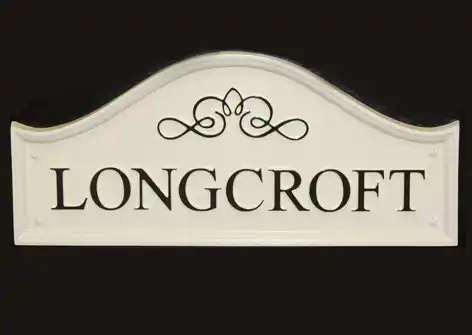 Dome top cast sign with scroll detail