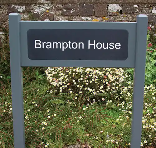 Handcrafted oak entrance sign with engraved corian plaque
