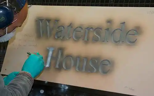 Painting letters in slate sign