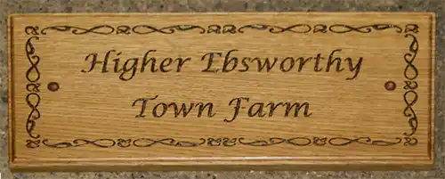 Wooden sign with fine lettering and detailed border