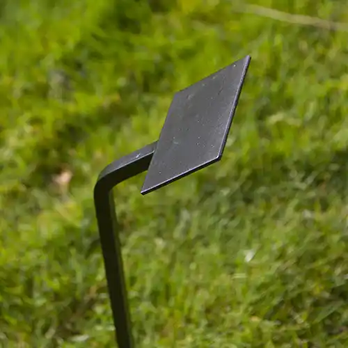 Wrought iron spike tree stake with flat plate