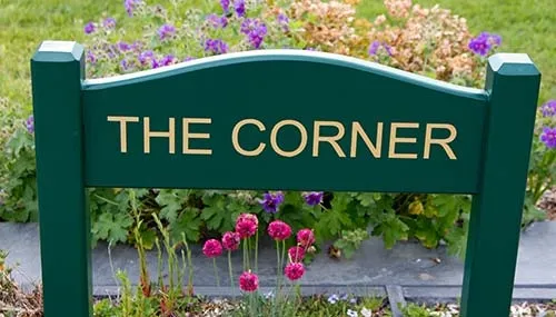 Painted hardwood sign morticed into posts. Painted House Sign on Posts