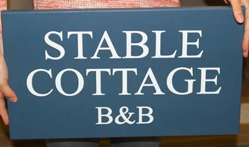 Painted signs look far more traditional than vinyl signage. Painted House Sign for B&B