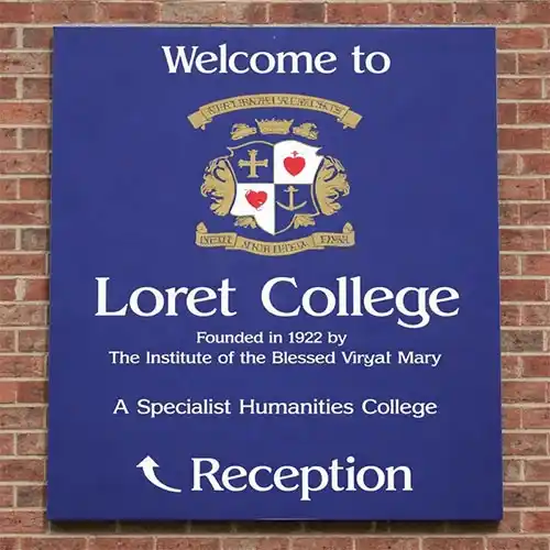 Hidden Fixings for a Clean, Professional Finish Blue aluminium tray sign with folded returns mounted to brick wall